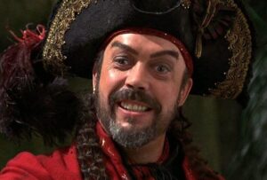 Tim Curry as "Long John SIlver," where he sang "Professionasl Pirate."